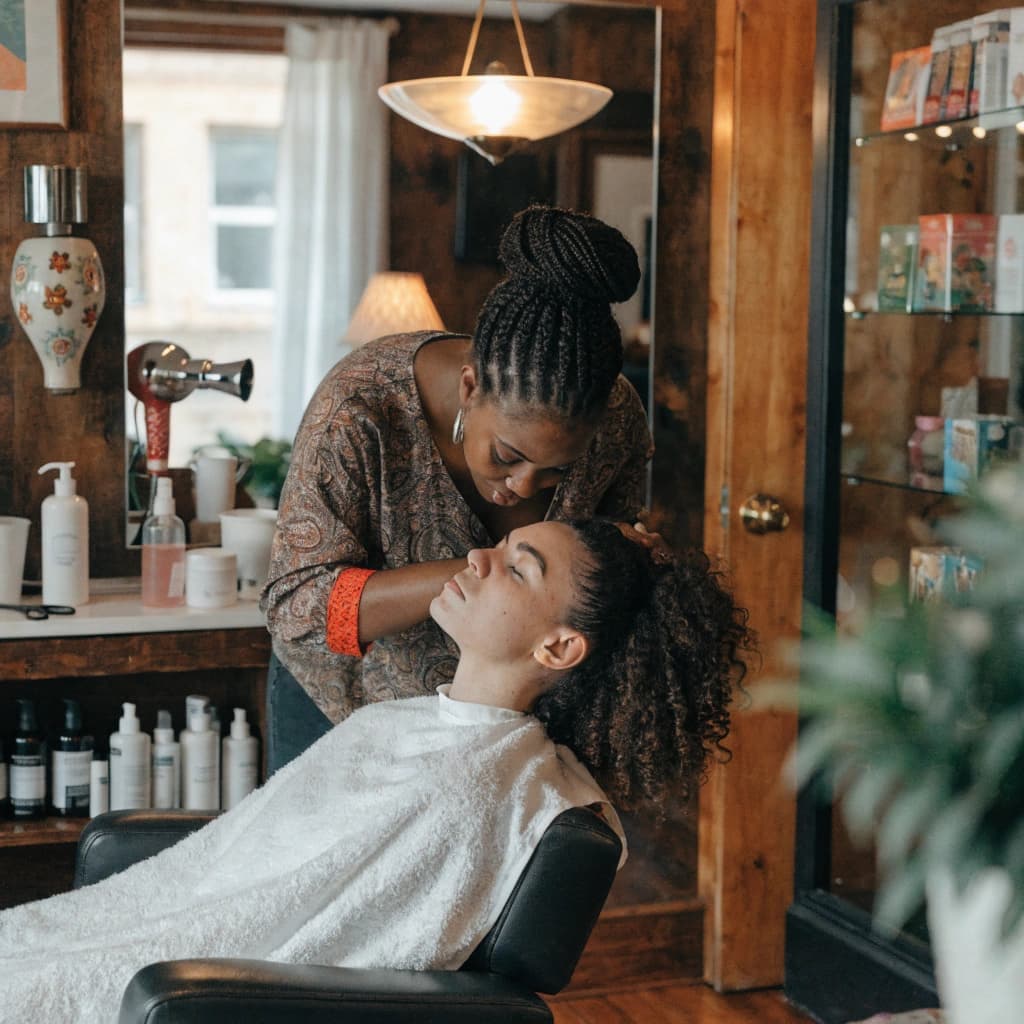 Customer receiving a salon service at a local beauty business